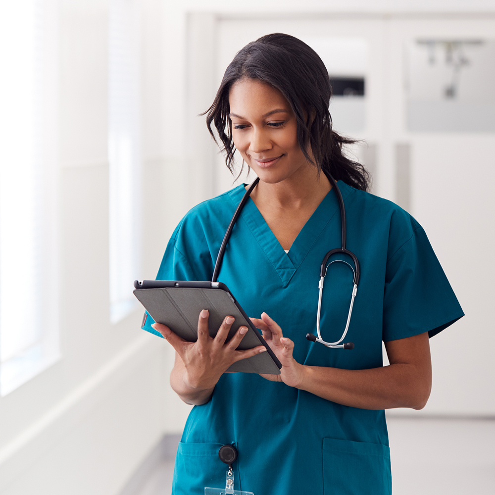 female medical professional working on tablet